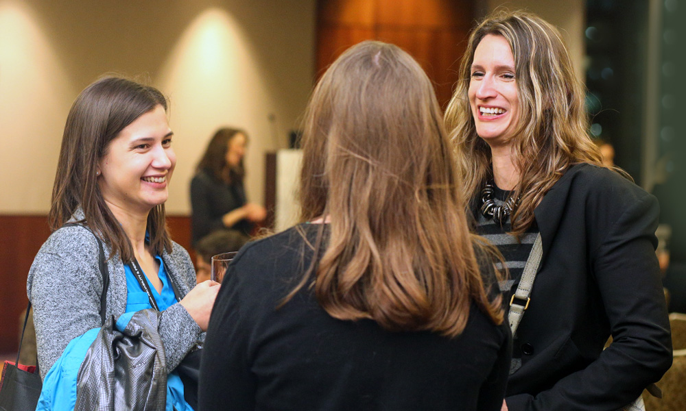 Three people sharing a moment of connection at an SPIE event