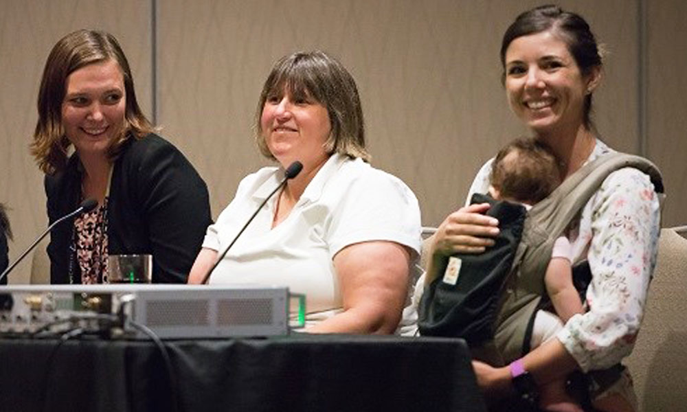 Woman holding child during SPIE event