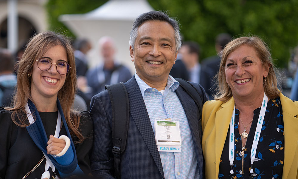 Three SPIE members gather together for a group photo at the Welcome Reception