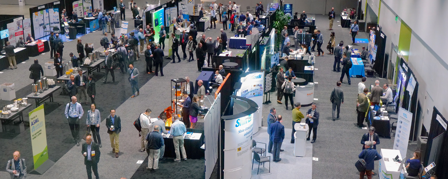 Overlooking a large crowd of people and booths at the exhibition