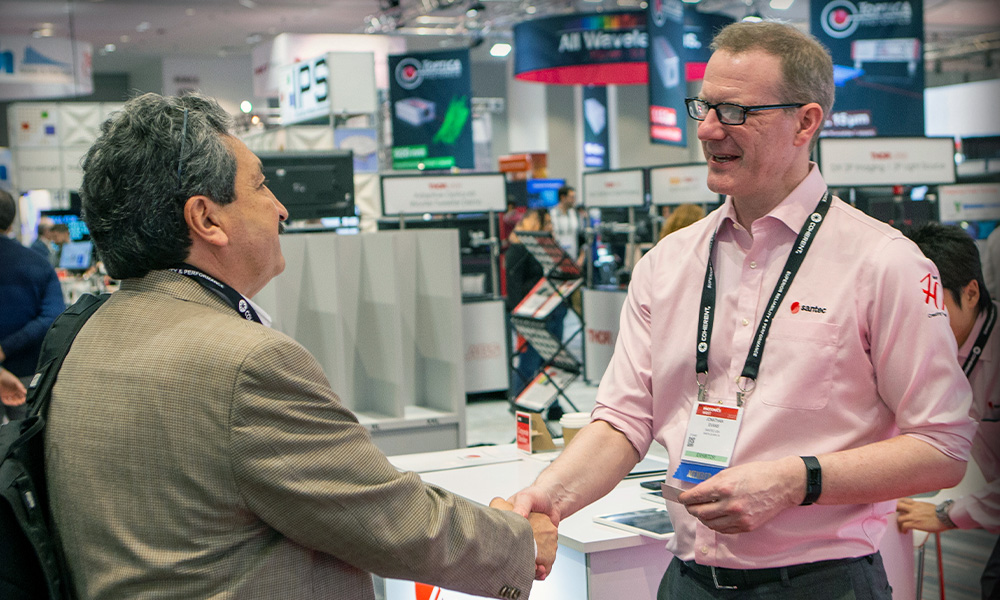 Shaking hands on an SPIE exhibition floor