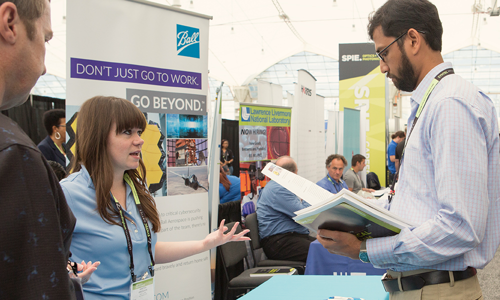 Exhibitor greets attendees at his booth