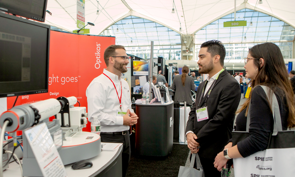 Attendees visiting booths on the exhibition floor