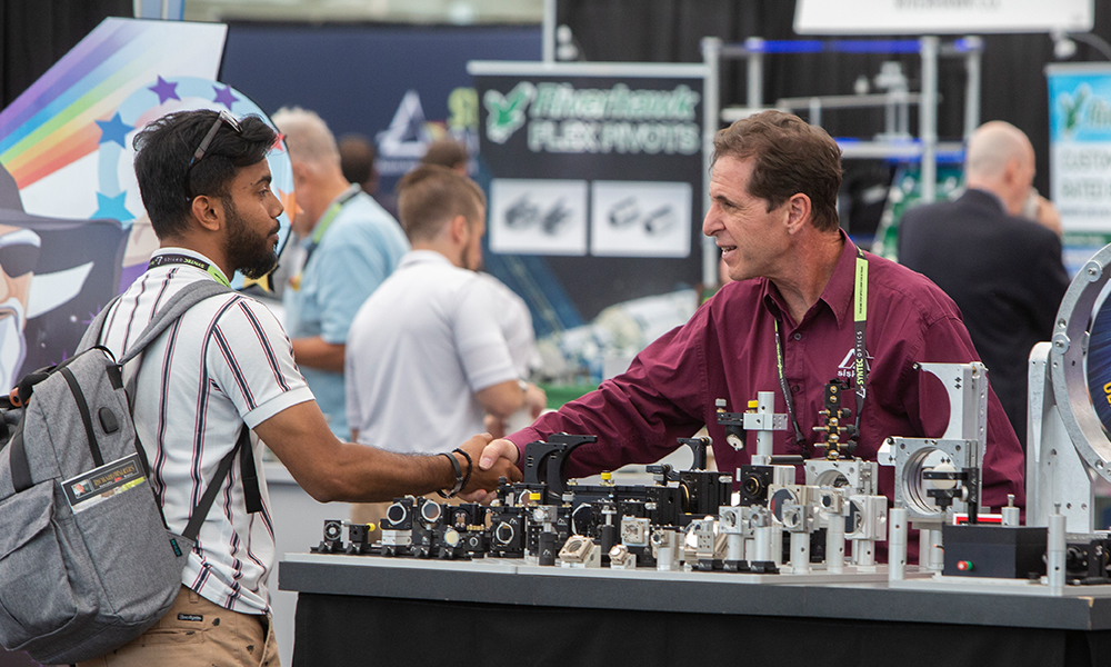 Attendee interacting with exhibitor 