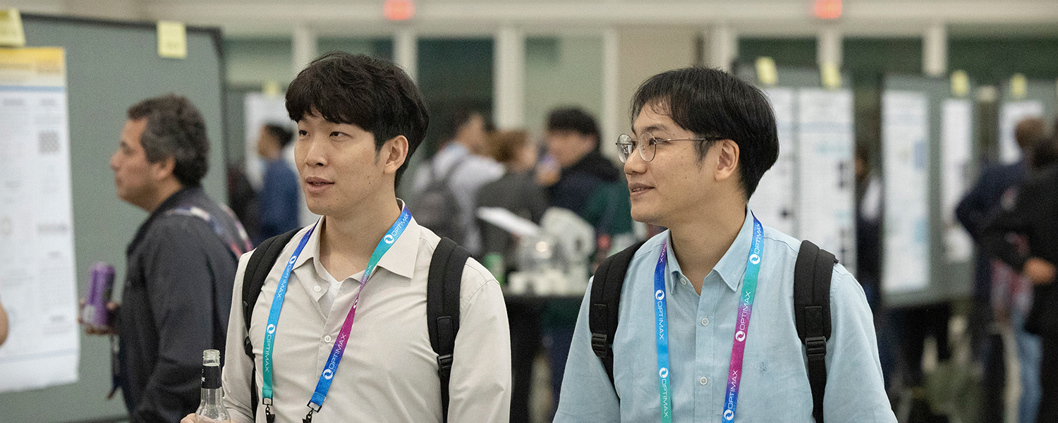 Two male students walk the hall of SPIE Advanced Lithography + Patterning