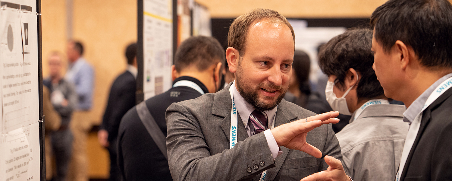 Author explains their research at a poster session at SPIE Photonics West