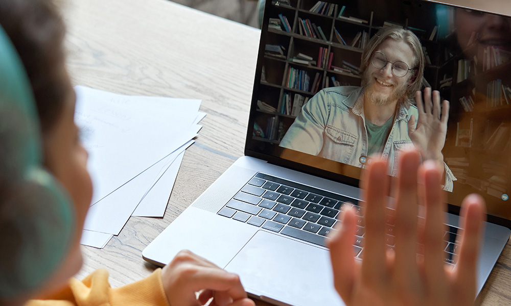 Woman sitting at desk presenting a webinar