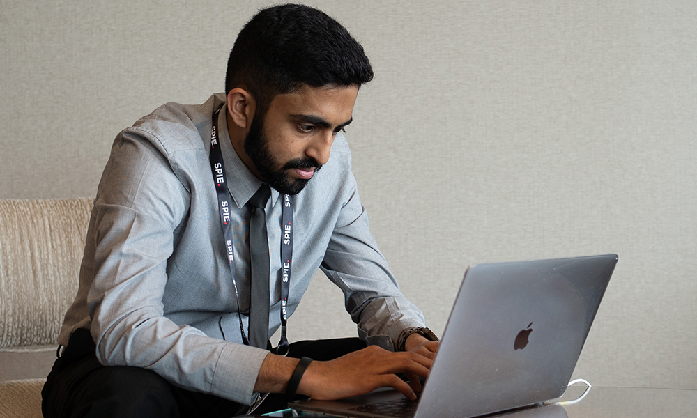 Man looks at computer for contact information