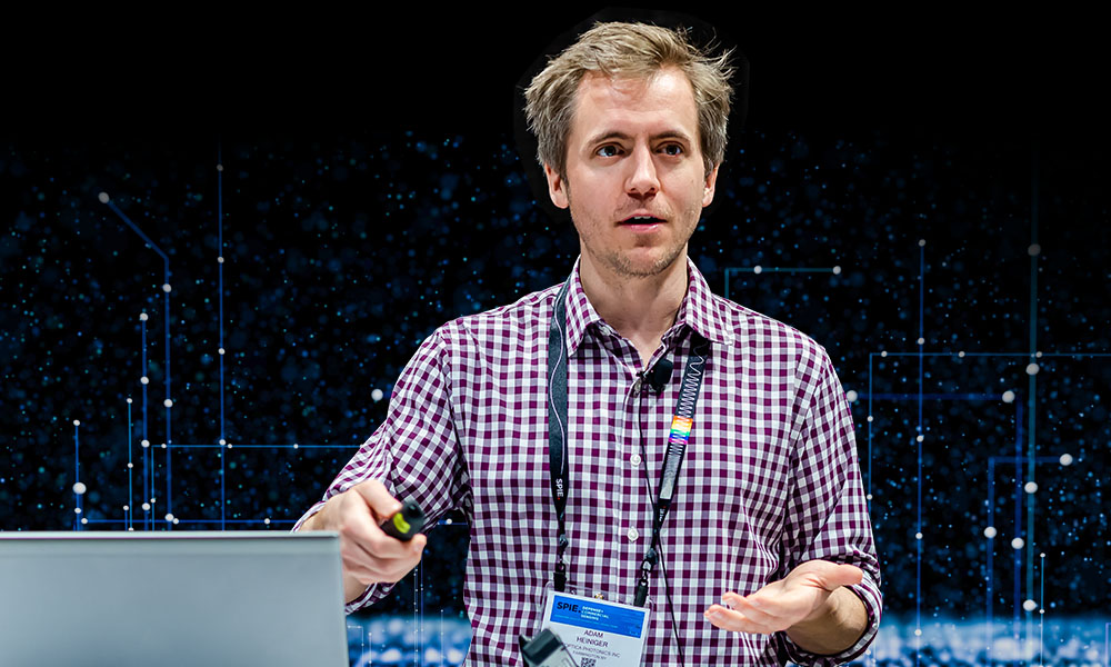 Man presenting during webinar with computer in foreground