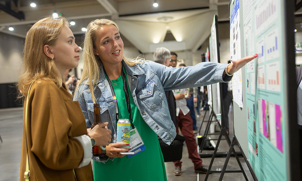 An author presenting a poster for SPIE Optical Systems Design