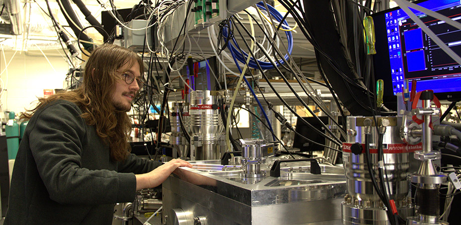 Nicholas Jenkins, recipient of the 2024 Nick Cobb Memorial Scholarship, adjusting metal filters and an in-vacuum iris on an EUV imaging reflectometer.